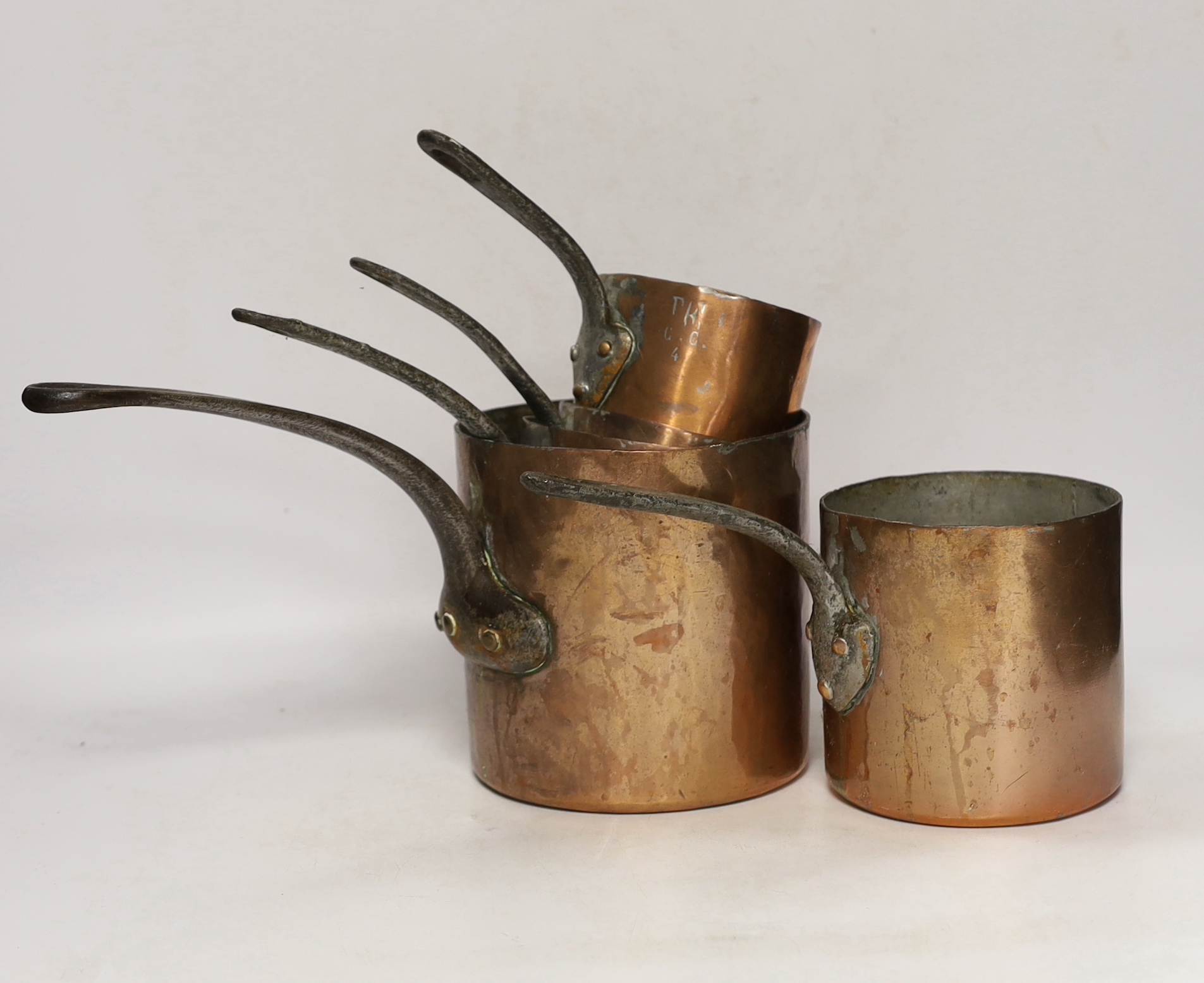 A set of five French graduated copper saucepans, largest 33cm wide